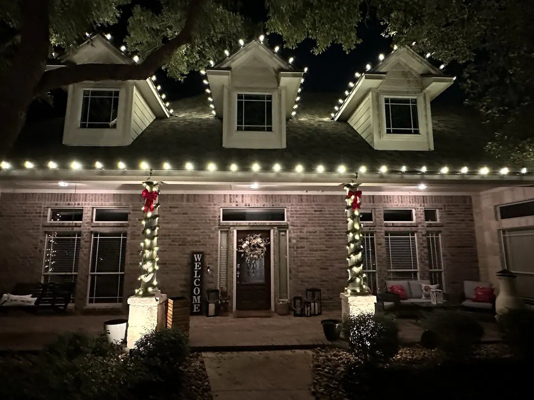 Dormers and wreaths lit with warm white bulbs