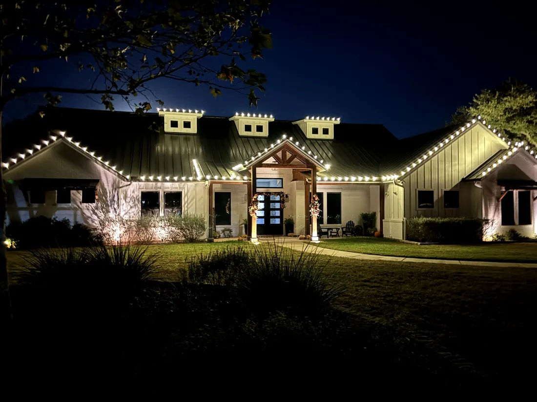 Warm white roofline on a standing-seam metal roof