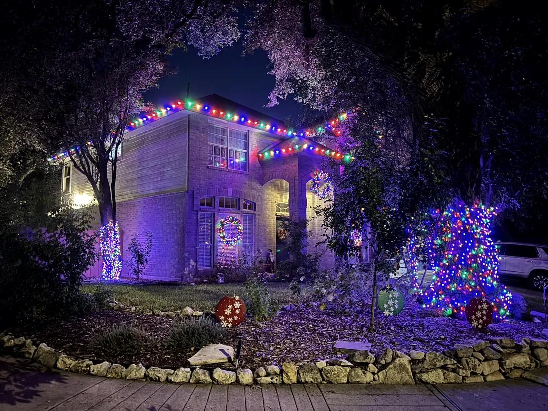 Multicolour roofline lighting with a decorated yard
